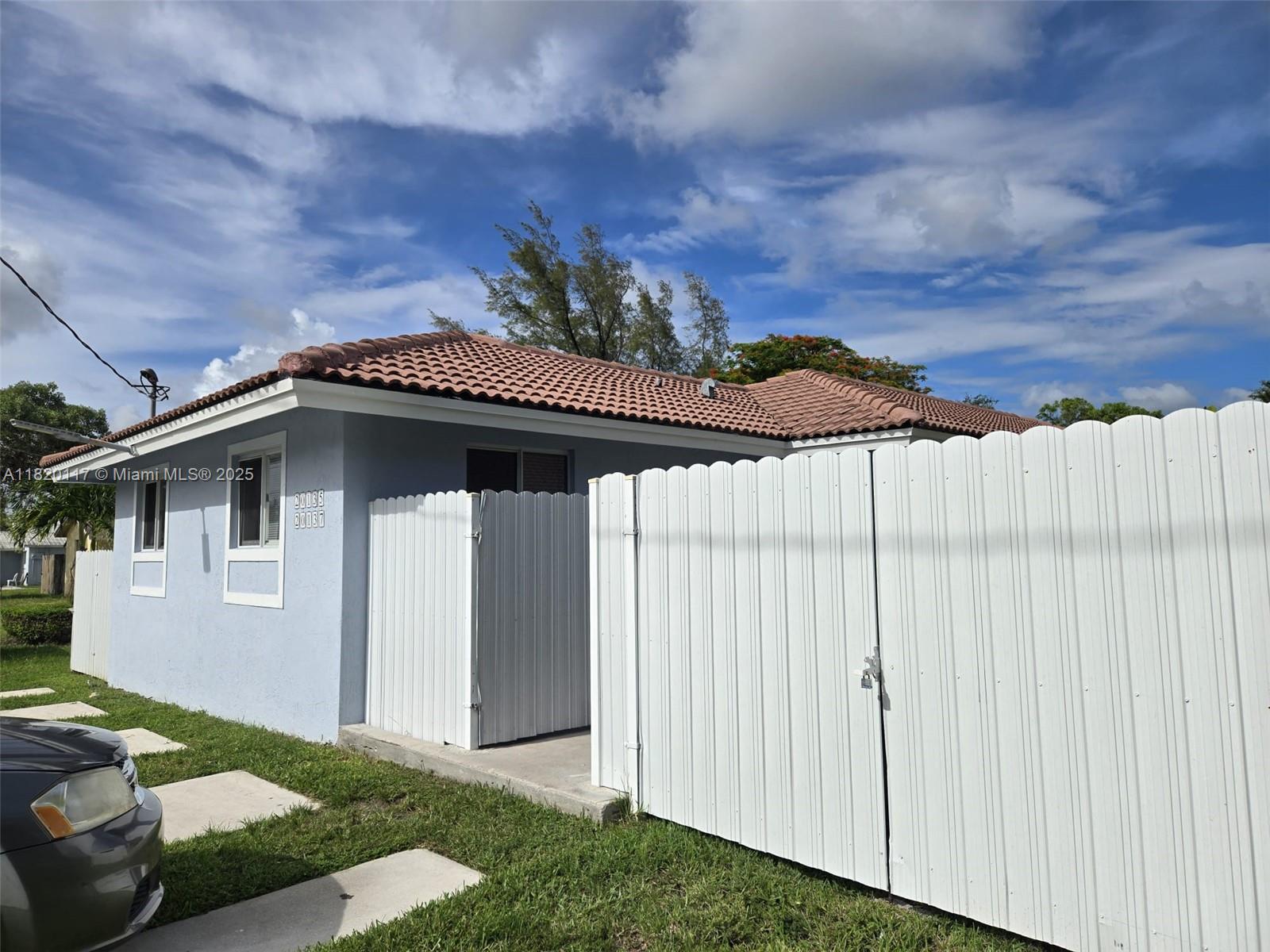 20137 Southwest 88th Court, Unit 20135 Cutler Bay, FL 33189 - Photo 26 of 33 a view of a house with a yard