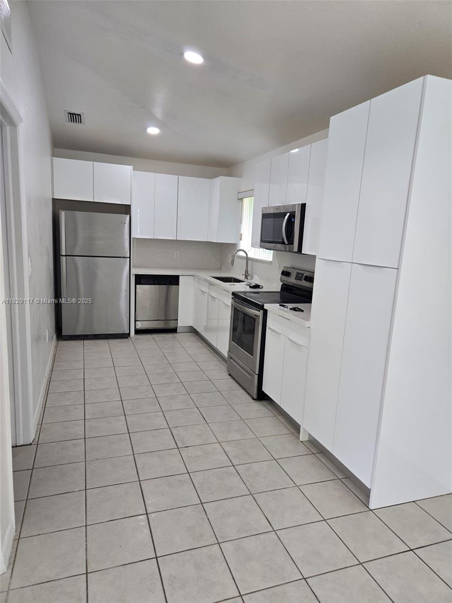 20137 Southwest 88th Court, Unit 20135 Cutler Bay, FL 33189 - Photo 4 of 33 a kitchen with stainless steel appliances a refrigerator sink and cabinets