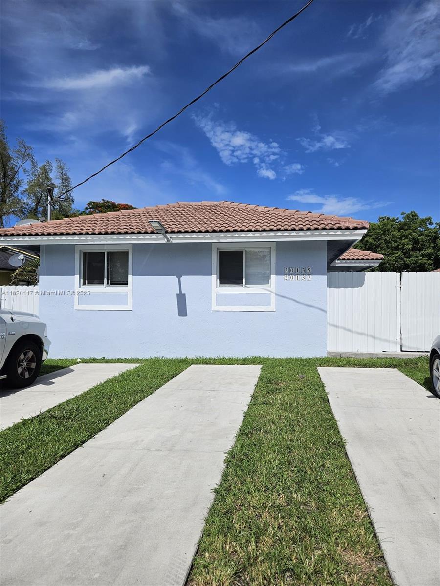 20137 Southwest 88th Court, Unit 20135 Cutler Bay, FL 33189 - Photo 5 of 33 a front view of a house with a yard