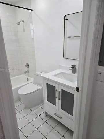 a bathroom with a sink vanity granite toilet and shower