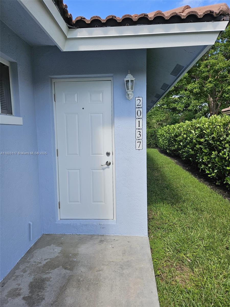20137 Southwest 88th Court, Unit 20135 Cutler Bay, FL 33189 - Photo 7 of 33 a view of backyard with potted plants