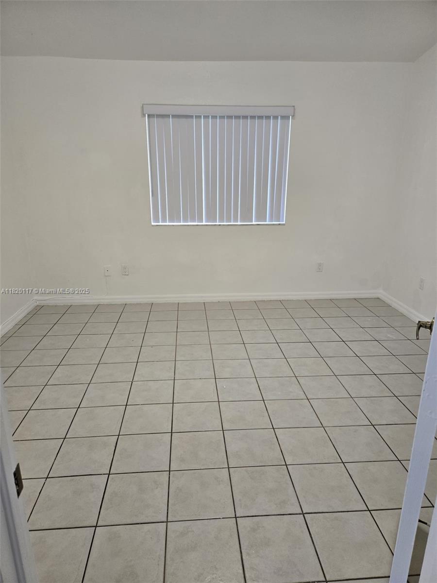 20137 Southwest 88th Court, Unit 20135 Cutler Bay, FL 33189 - Photo 8 of 33 a view of an empty room and a window