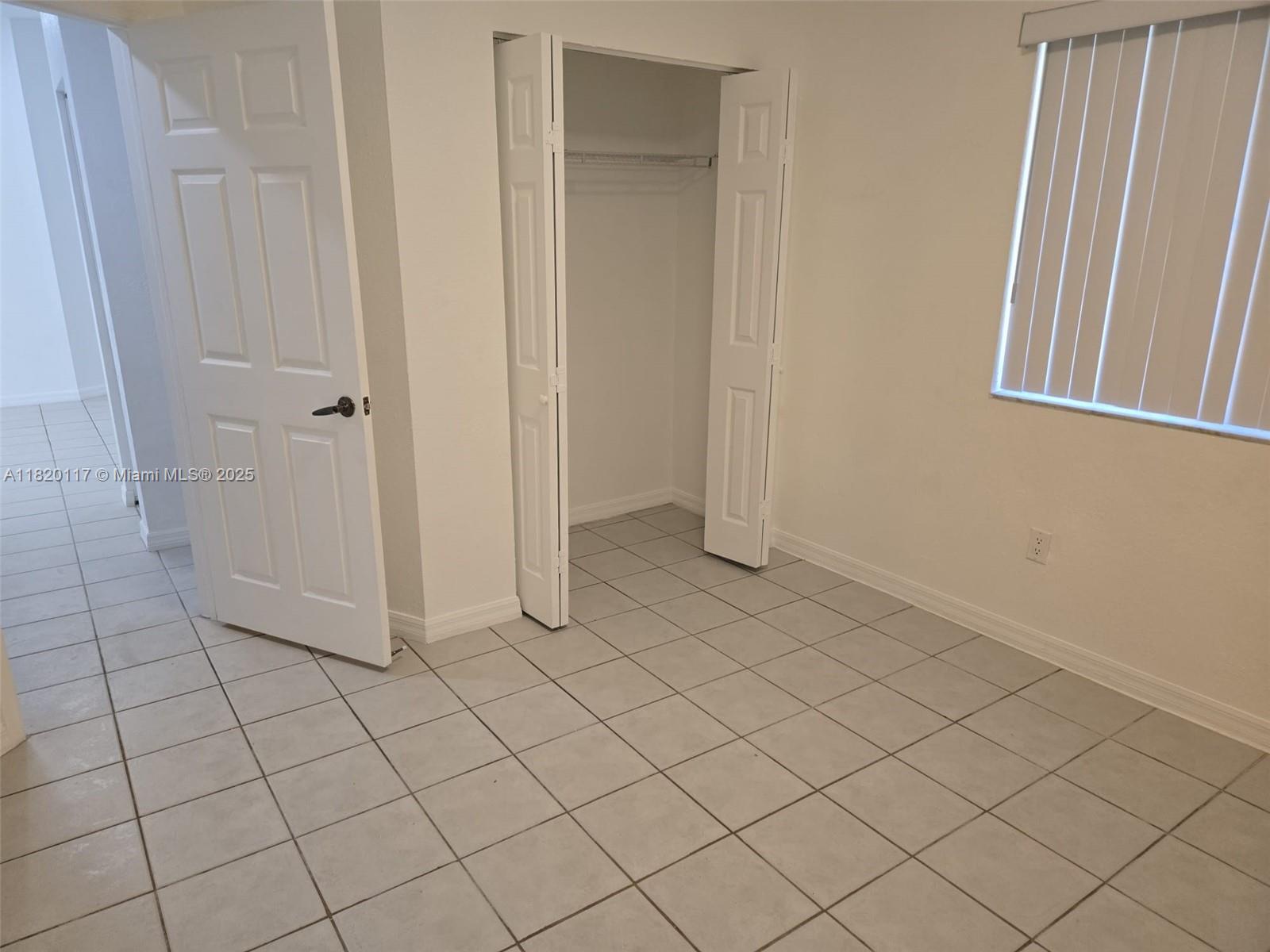 20137 Southwest 88th Court, Unit 20135 Cutler Bay, FL 33189 - Photo 9 of 33 an empty room with white door