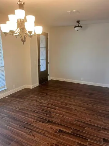 a view of a room with wooden floor and staircase