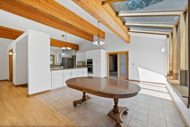 a kitchen with stainless steel appliances granite countertop a stove and cabinets