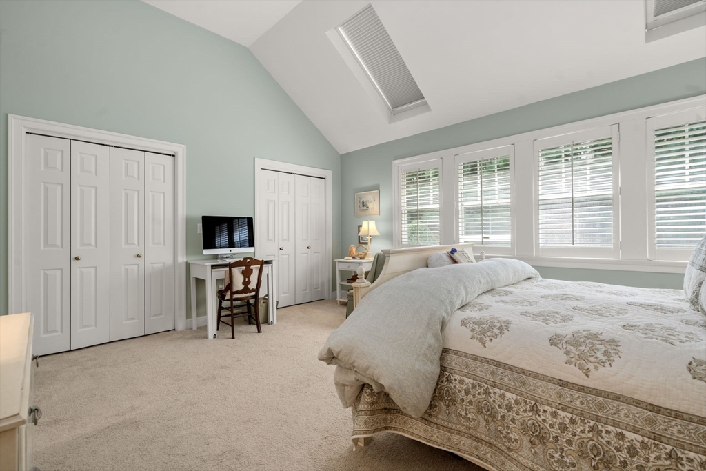 9 Highcroft Way, Unit 9 Hopkinton, MA 01748 - Photo 15 of 22 a bedroom with a bed and a flat screen tv