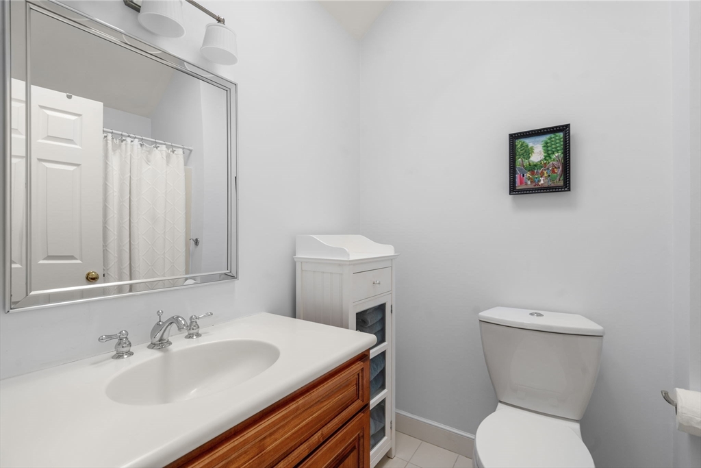 9 Highcroft Way, Unit 9 Hopkinton, MA 01748 - Photo 18 of 22 a bathroom with a sink a toilet and a mirror