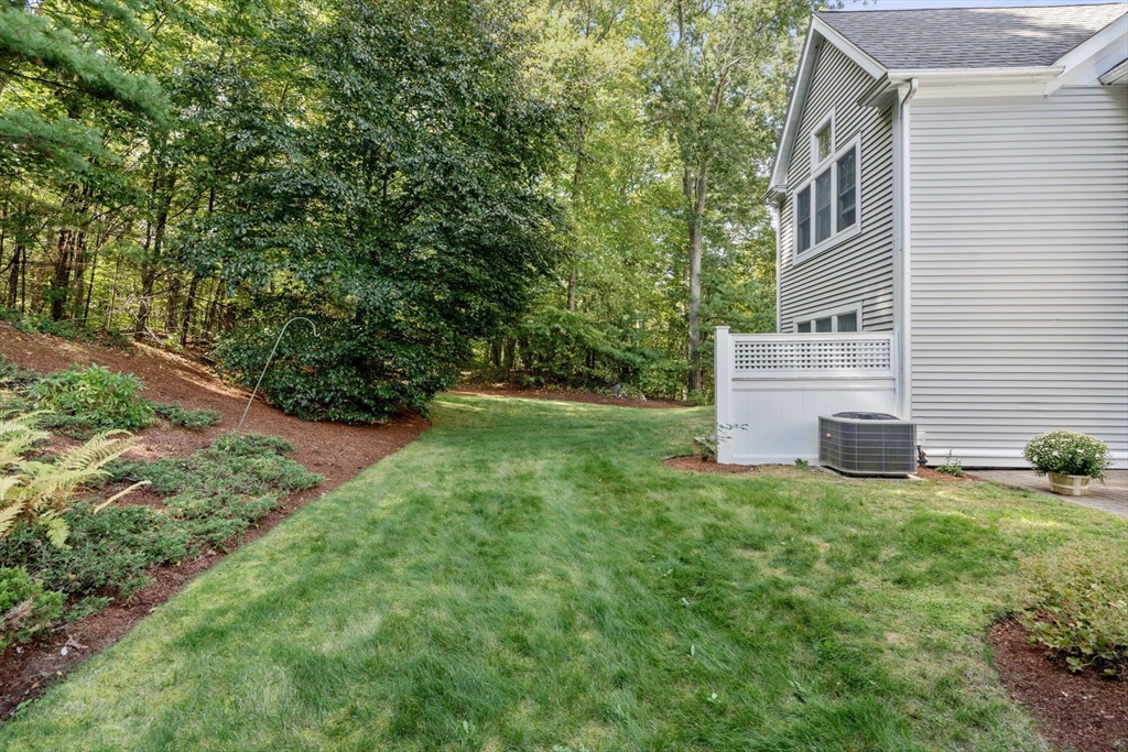 9 Highcroft Way, Unit 9 Hopkinton, MA 01748 - Photo 21 of 22 a view of backyard with barbeque grill and a big yard