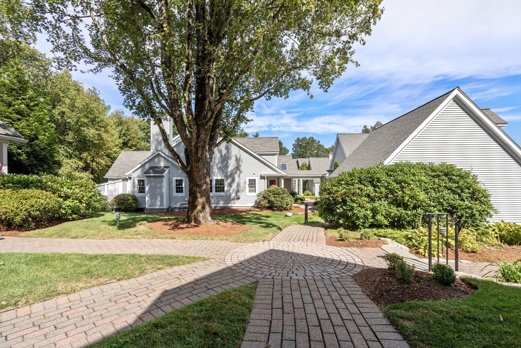 9 Highcroft Way, Unit 9 Hopkinton, MA 01748 - Photo 22 of 22 a front view of a house with a yard and trees