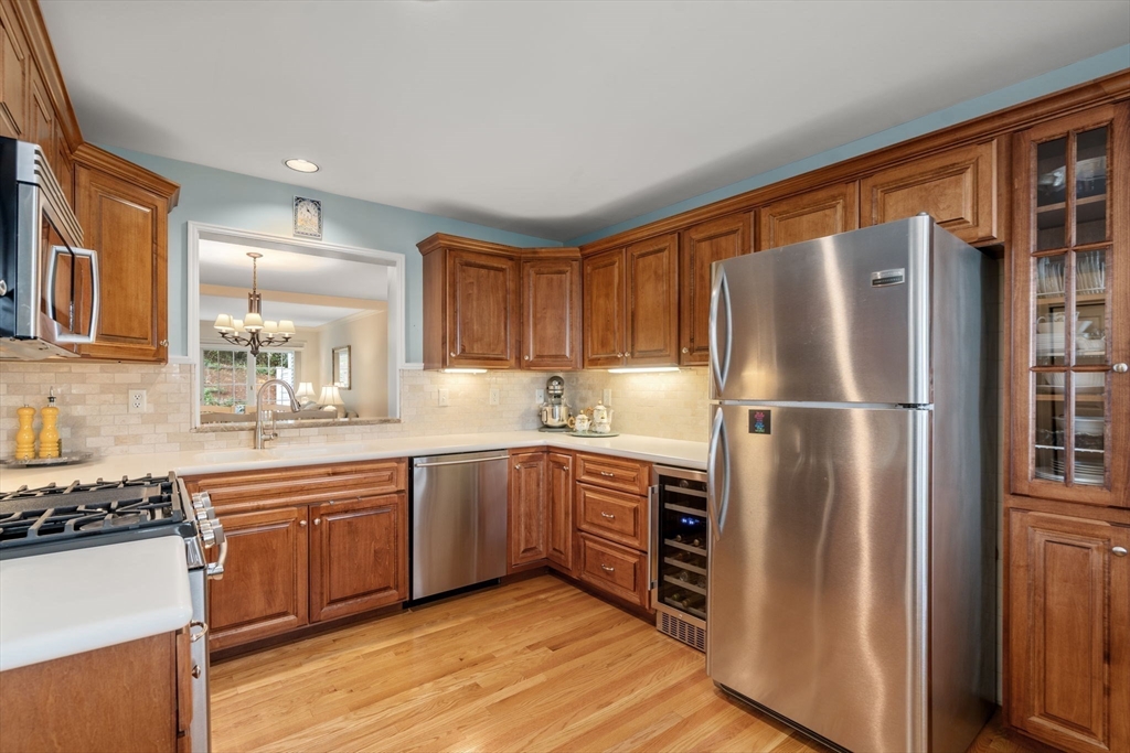 9 Highcroft Way, Unit 9 Hopkinton, MA 01748 - Photo 5 of 22 a kitchen with stainless steel appliances granite countertop a refrigerator and a stove top oven