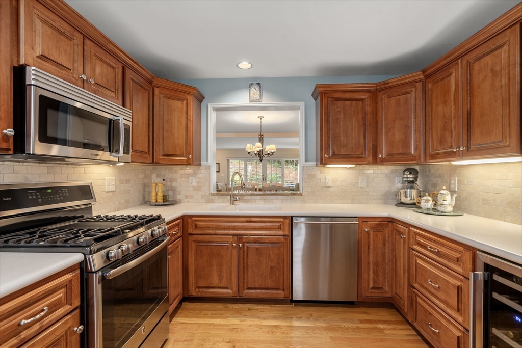 9 Highcroft Way, Unit 9 Hopkinton, MA 01748 - Photo 6 of 22 a kitchen with stainless steel appliances granite countertop a sink stove and microwave