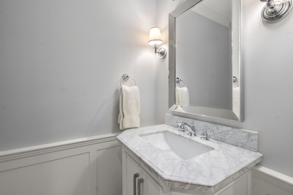 9 Highcroft Way, Unit 9 Hopkinton, MA 01748 - Photo 8 of 22 a bathroom with a sink and a mirror