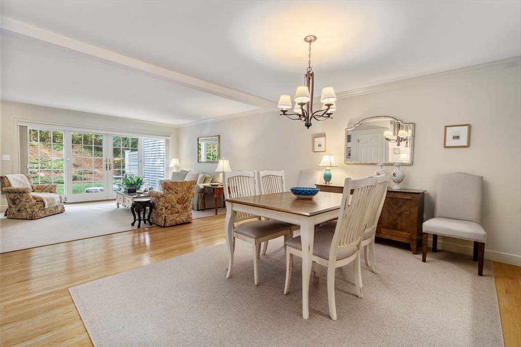 9 Highcroft Way, Unit 9 Hopkinton, MA 01748 - Photo 10 of 22 a view of a dining room with furniture and a chandelier