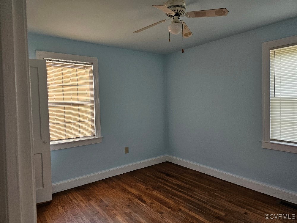 1608 Enon Church Road Chester, VA 23836 - Photo 5 of 8 an empty room with wooden floor fan and windows
