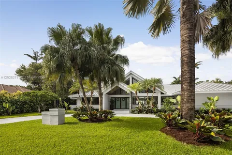 a view of a house with swimming pool and porch with furniture