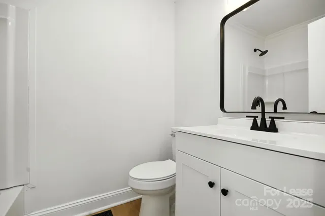 a bathroom with a sink a toilet and mirror