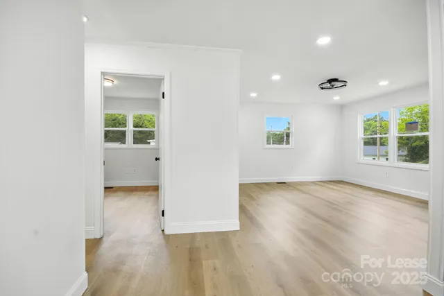 an empty room with windows and entrance