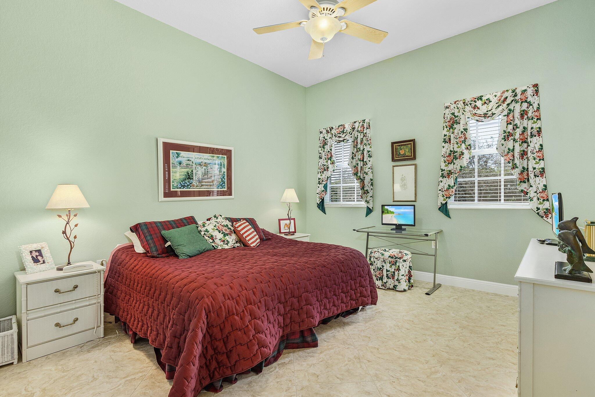 9283 Museo Circle, Unit 204 Naples, FL 34114 - Photo 12 of 23 a bedroom with a bed and a chandelier