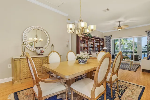 a view of a dining room with furniture a chandelier and wooden floor