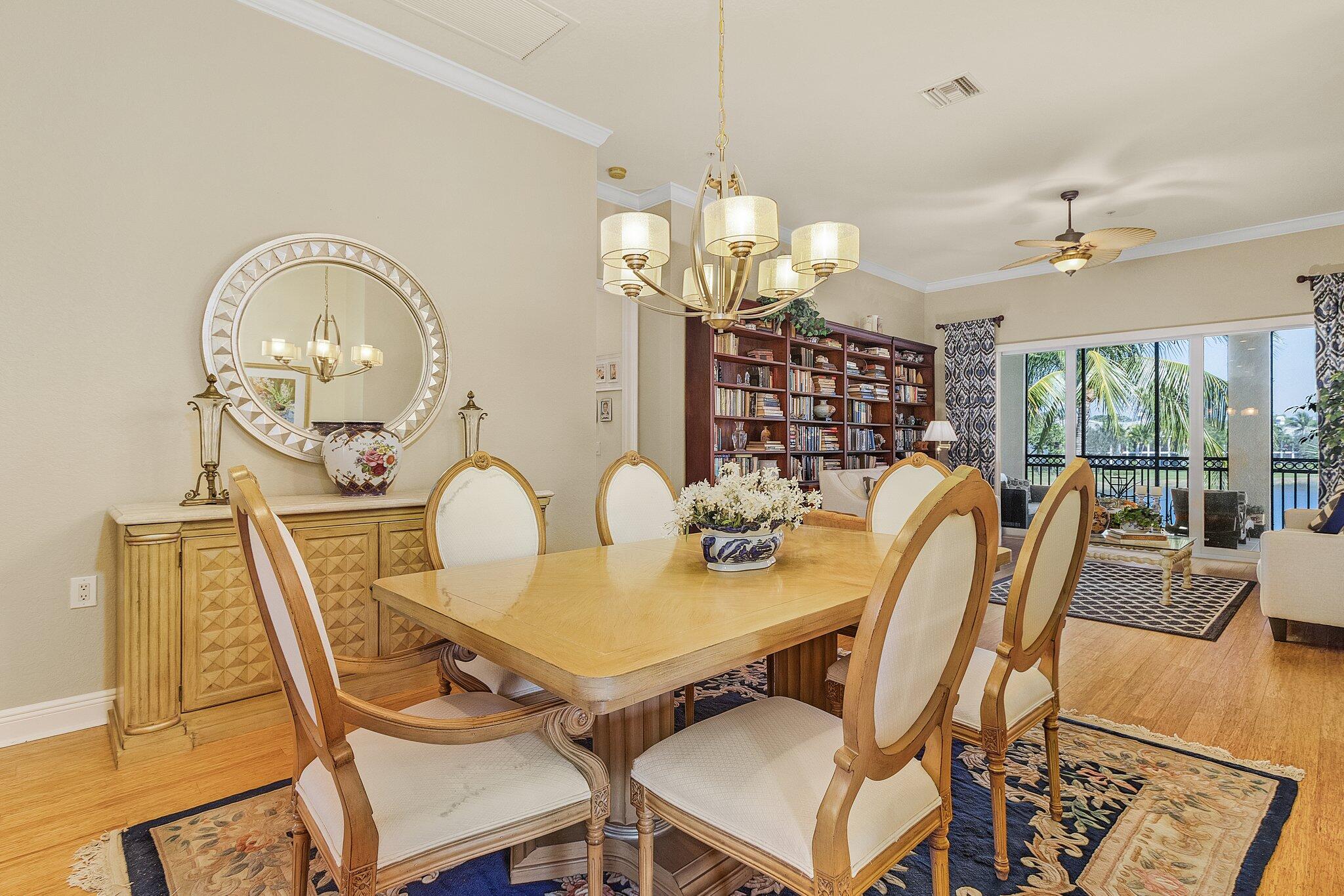 9283 Museo Circle, Unit 204 Naples, FL 34114 - Photo 8 of 23 a view of a dining room with furniture a chandelier and wooden floor