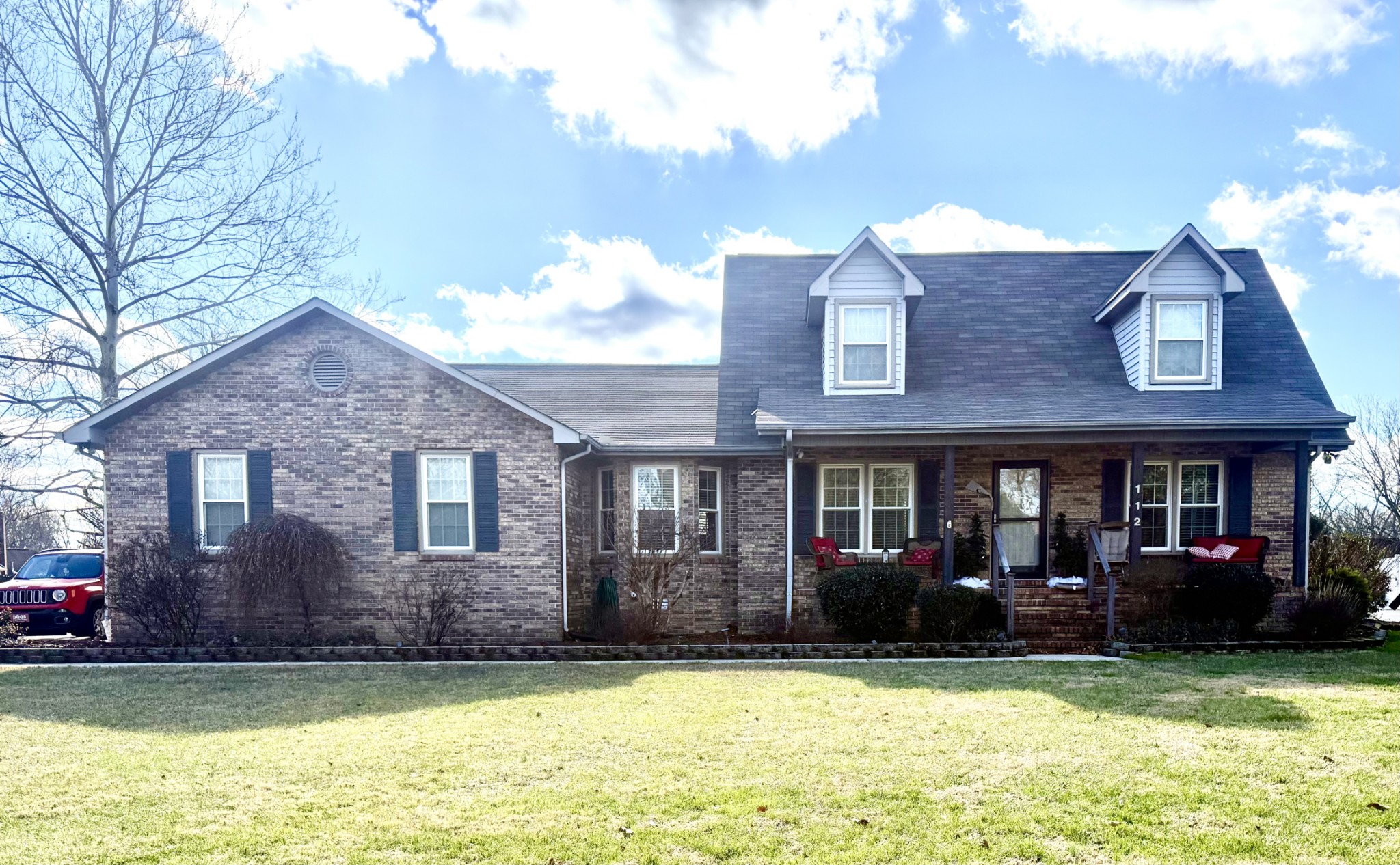 a view of a house with a swimming pool and a yard