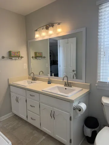 a bathroom with 2 sink and a toilet