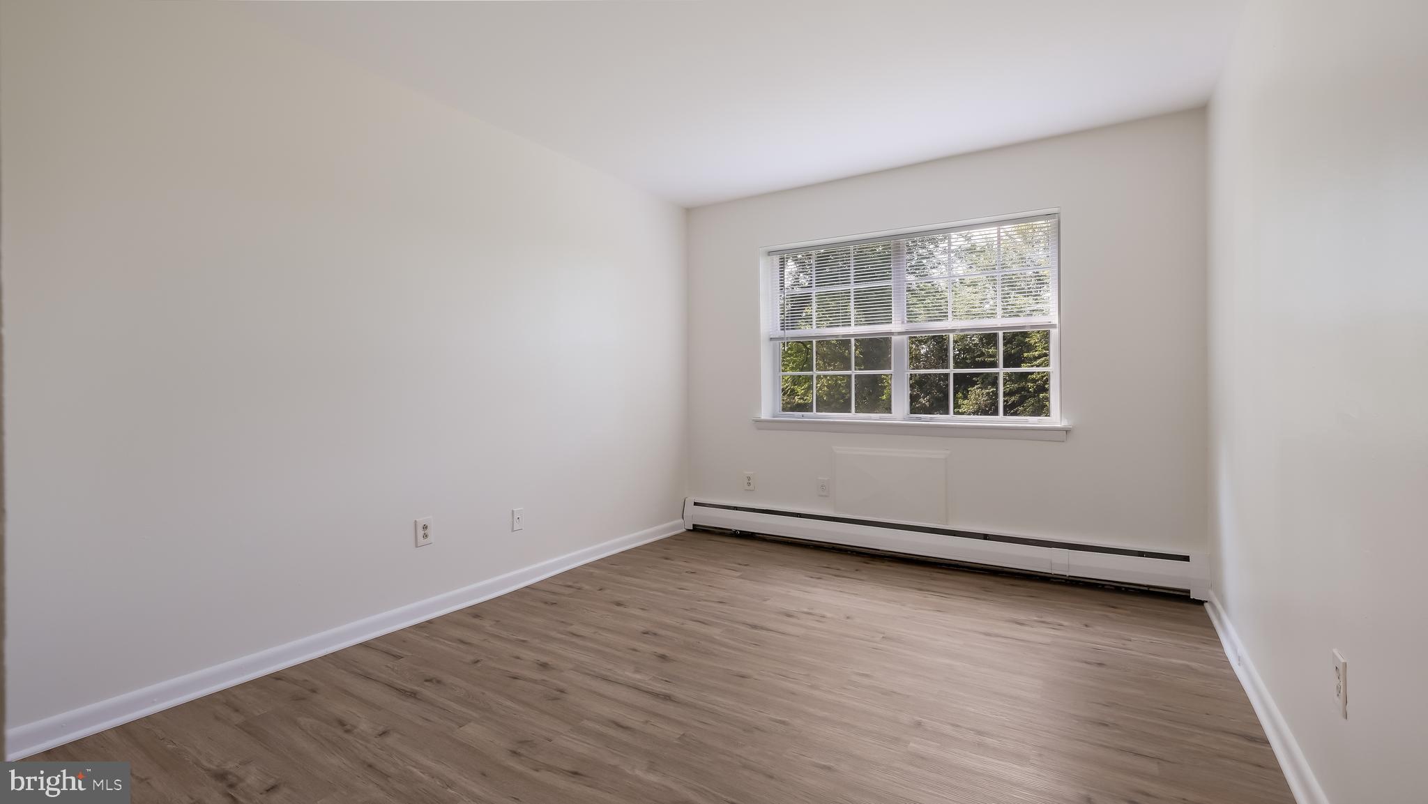 4701 Pennell Road Aston, PA 19014 - Photo 12 of 24 an empty room with wooden floor and windows