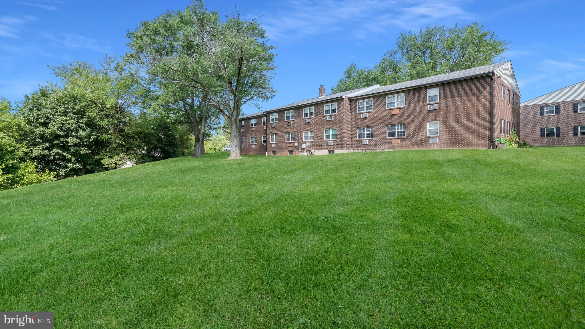 4701 Pennell Road Aston, PA 19014 - Photo 20 of 24 a view of a backyard with plants and large trees
