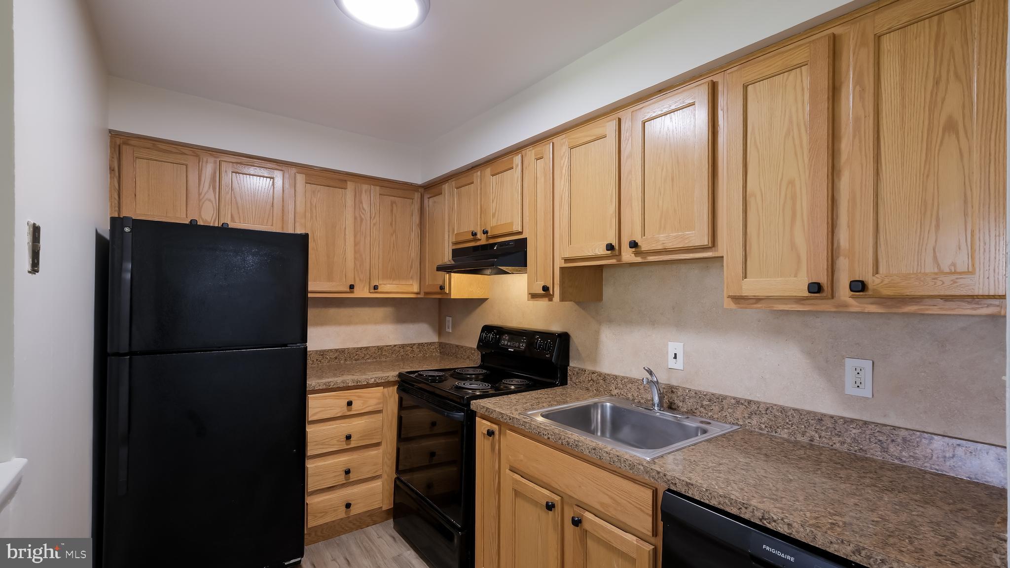 4701 Pennell Road Aston, PA 19014 - Photo 7 of 24 a kitchen with a refrigerator and a sink
