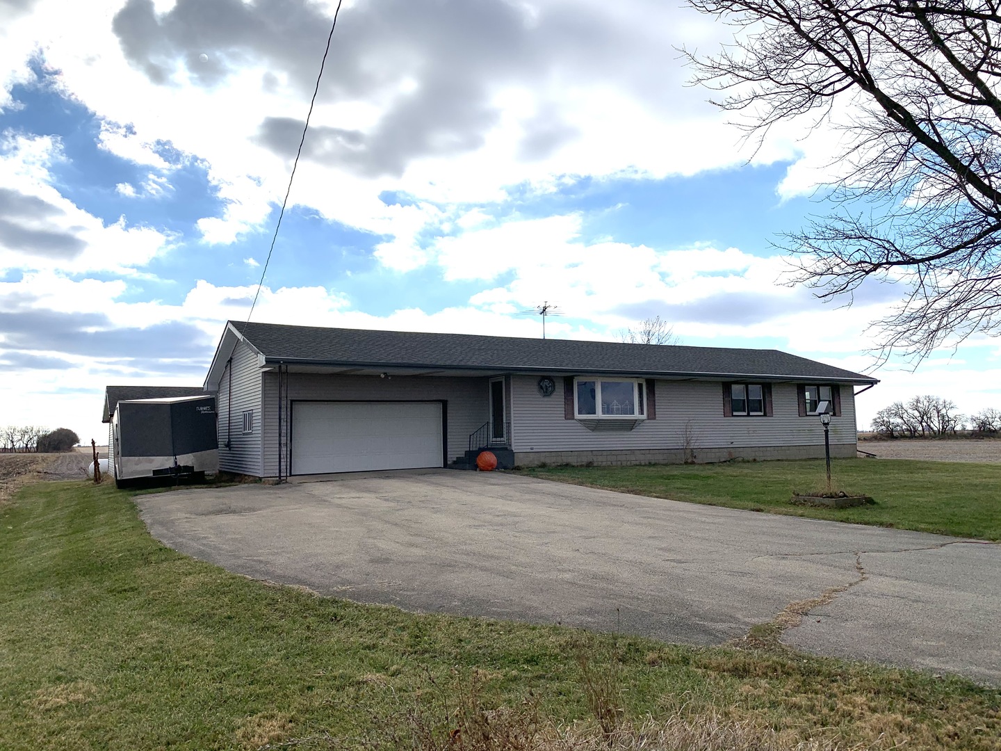 11624 Highway 17 Bonfield, IL 60913 - Photo 1 of 14 a front view of a house with a yard and garage