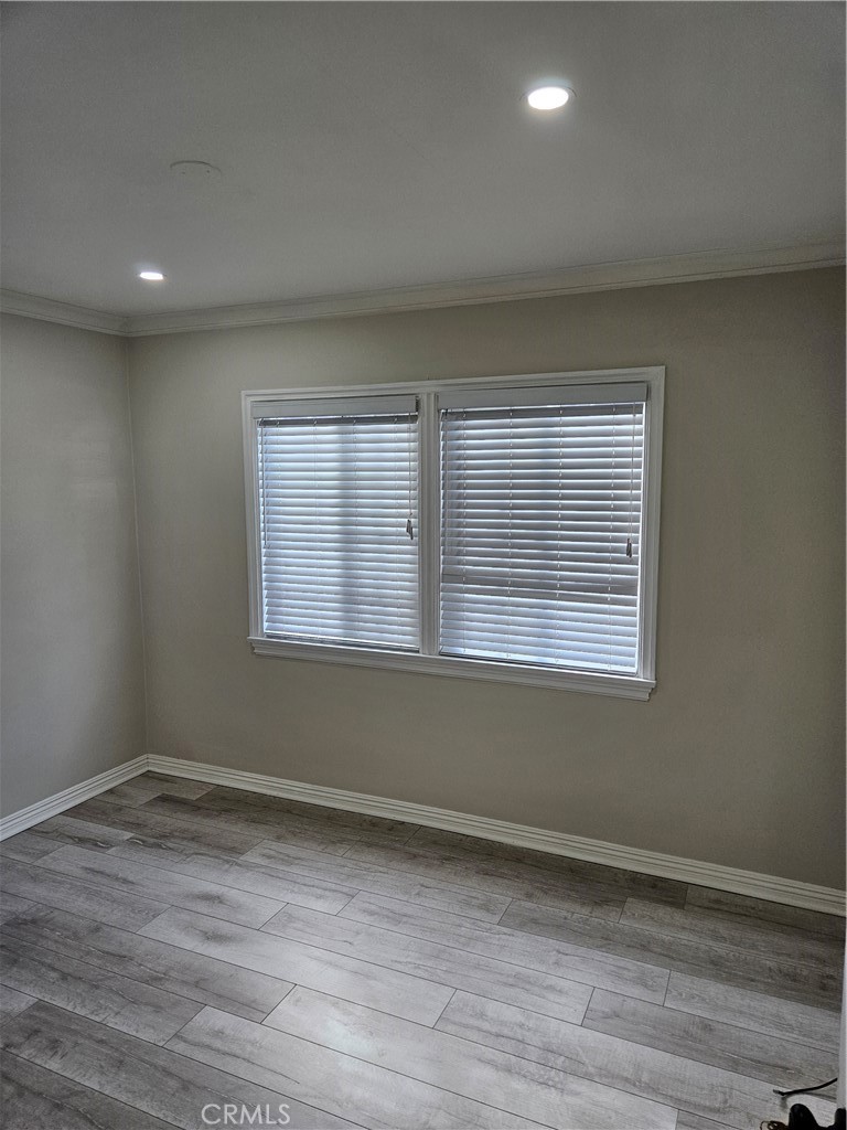 8030 Lemona Avenue Panorama City, CA 91402 - Photo 15 of 29 a view of an empty room with wooden floor and a window
