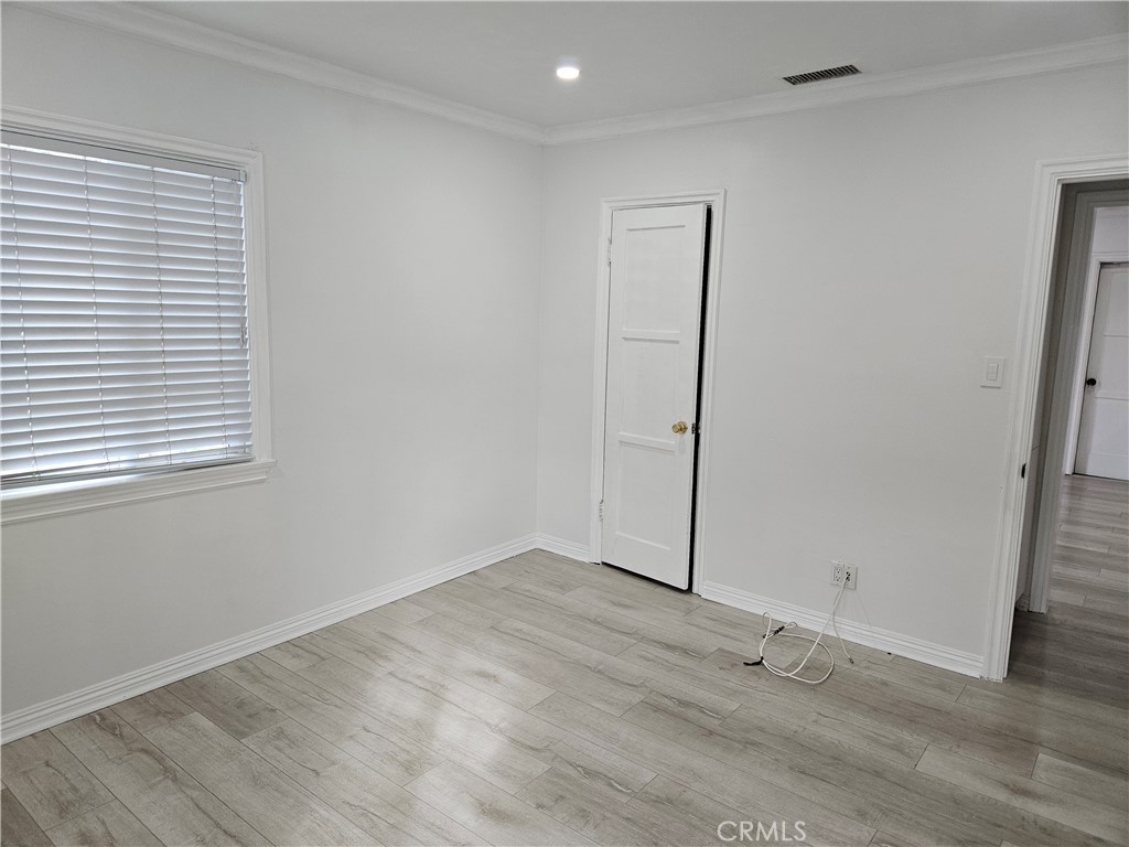 8030 Lemona Avenue Panorama City, CA 91402 - Photo 19 of 29 an empty room with wooden floor and window