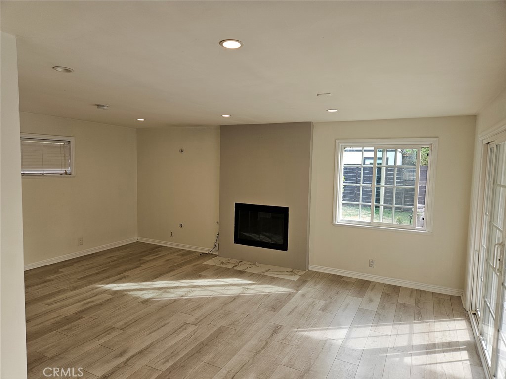 8030 Lemona Avenue Panorama City, CA 91402 - Photo 20 of 29 an empty room with wooden floor and windows