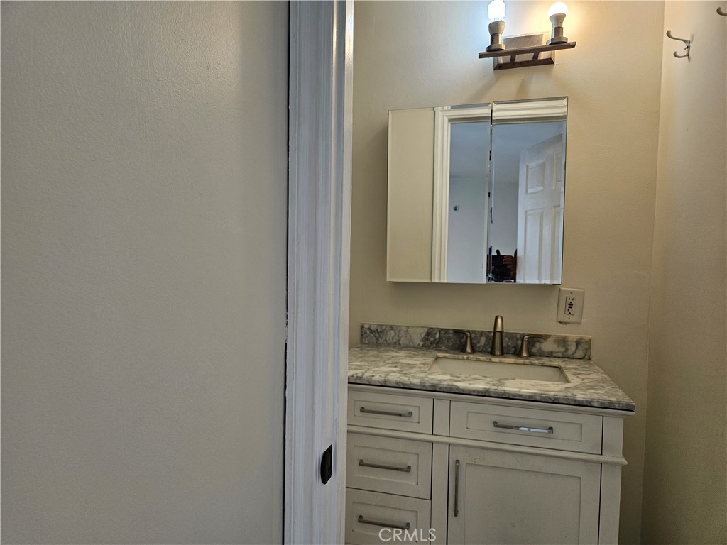 8030 Lemona Avenue Panorama City, CA 91402 - Photo 21 of 29 a bathroom with a granite countertop sink and a mirror