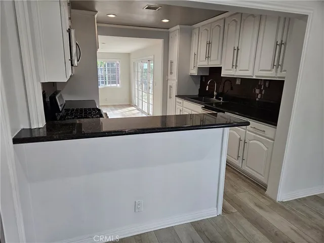 a kitchen with a sink and cabinets