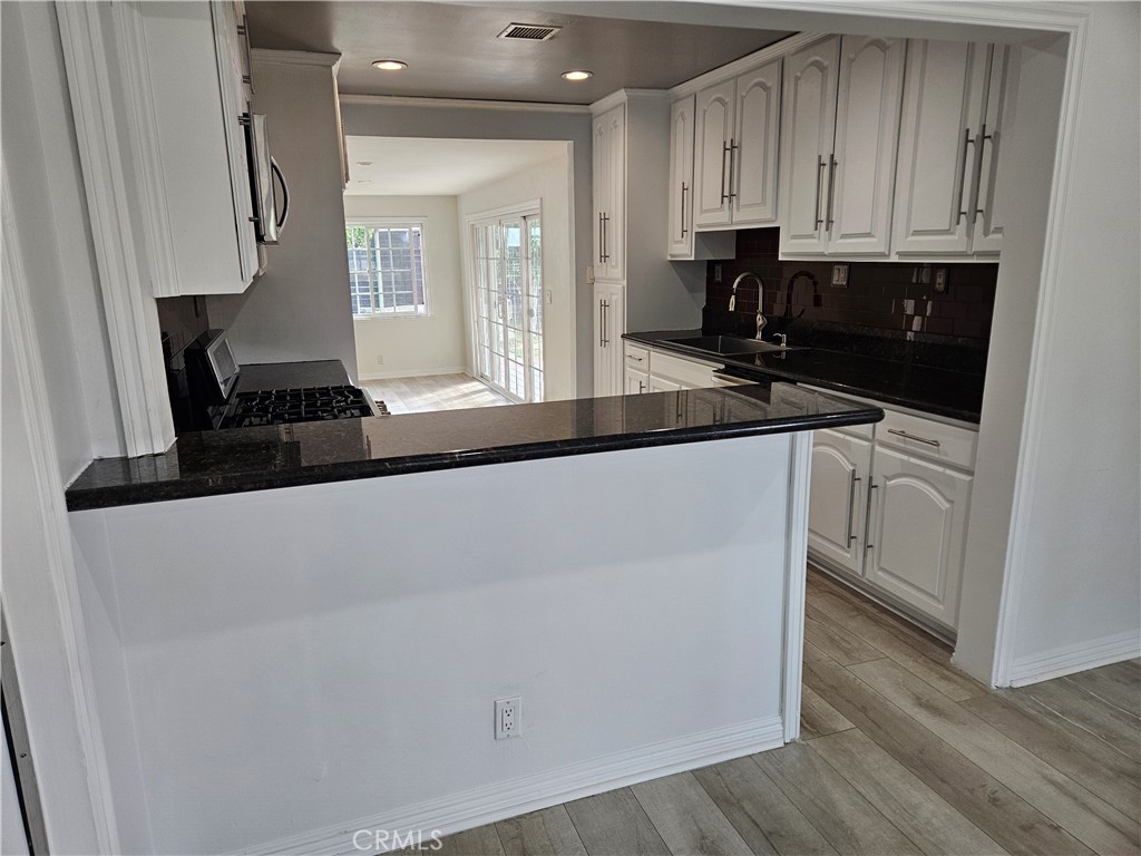 8030 Lemona Avenue Panorama City, CA 91402 - Photo 8 of 29 a kitchen with a sink and cabinets