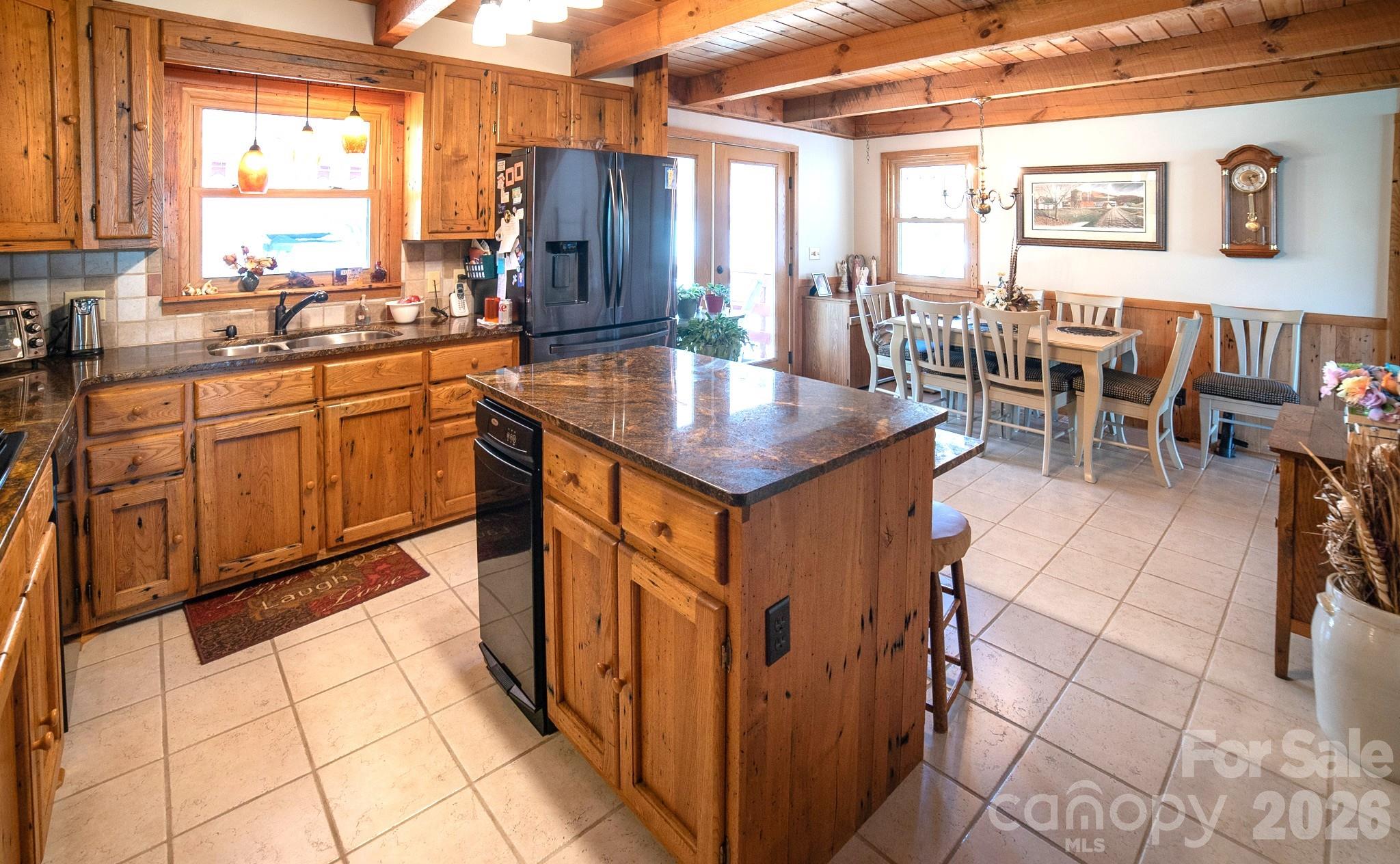 1368 Cajah Mountain Road Hudson, NC 28638 - Photo 16 of 46 a kitchen with lots of counter top space and dining table
