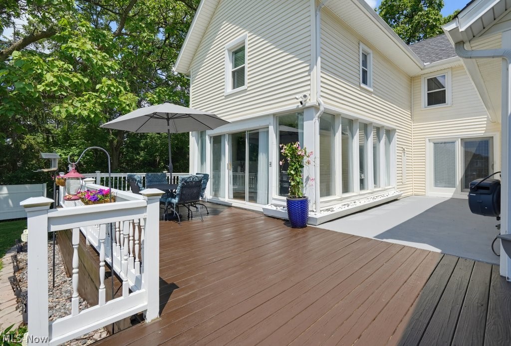 23055 Snell Road Columbia Station, OH 44028 - Photo 38 of 50 Expansive outdoor deck featuring wood-finish flooring, white railings, and direct access to a sunroom with multiple windows and sliding glass doors