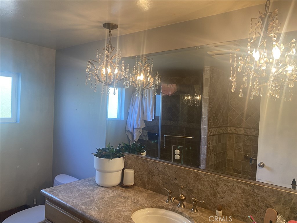 918 North Cleveland Street Orange, CA 92867 - Photo 3 of 5 a bathroom with a granite countertop sink a toilet and shower