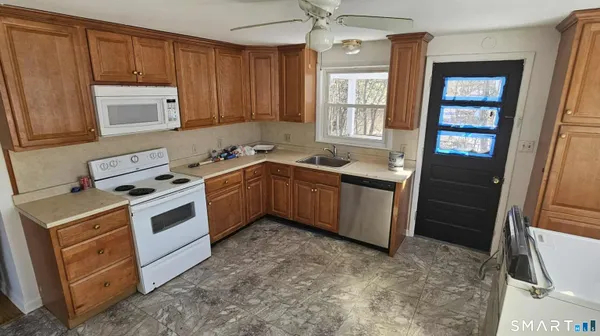 a kitchen with a stove sink and cabinets