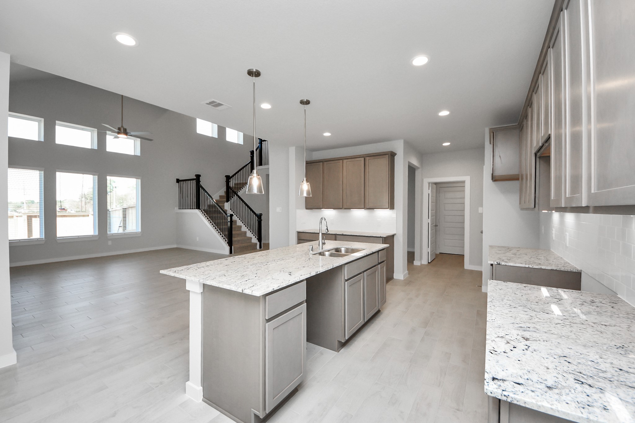 15807 Telge Ridge Lane Cypress, TX 77429 - Photo 11 of 45 a large kitchen with stainless steel appliances kitchen island a large counter top and a wooden floors