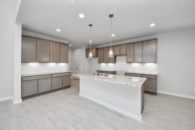 a large kitchen with kitchen island a sink stainless steel appliances and a cabinets