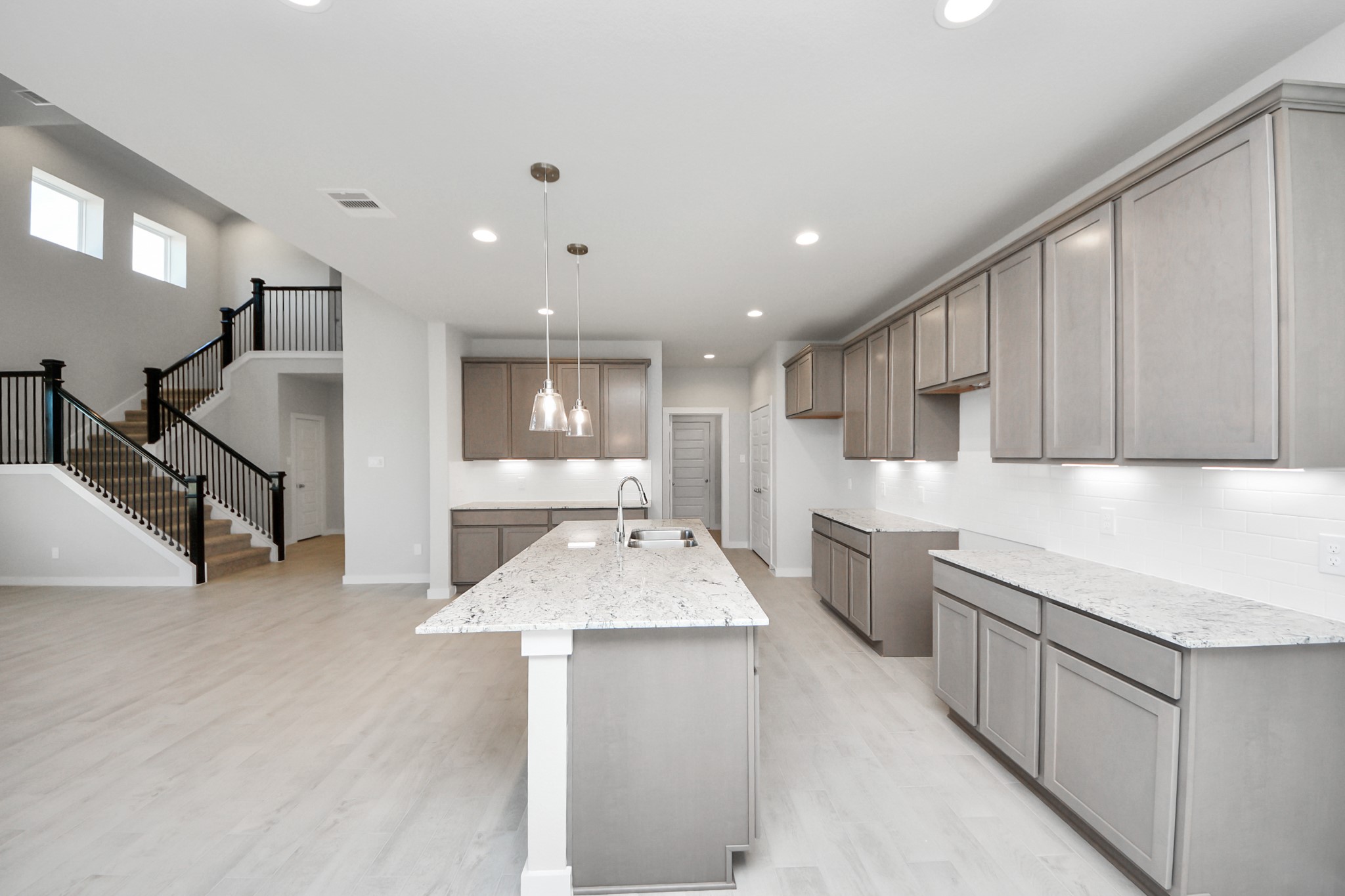 15807 Telge Ridge Lane Cypress, TX 77429 - Photo 13 of 45 a large kitchen with kitchen island a sink stainless steel appliances and a cabinets