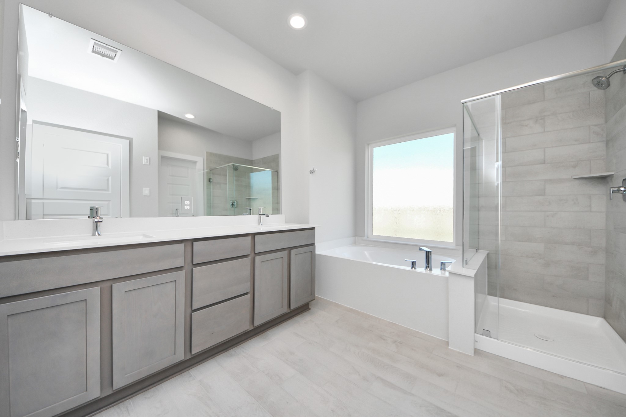 15807 Telge Ridge Lane Cypress, TX 77429 - Photo 25 of 45 a spacious bathroom with a tub sink shower and mirror