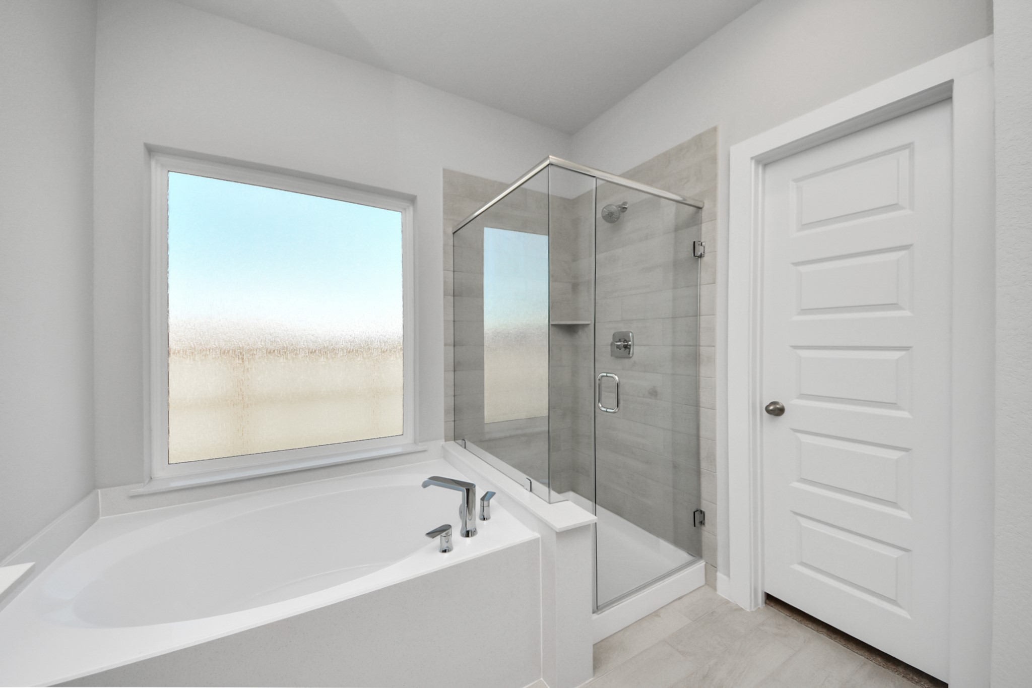 15807 Telge Ridge Lane Cypress, TX 77429 - Photo 27 of 45 a bathroom with a bathtub and a shower