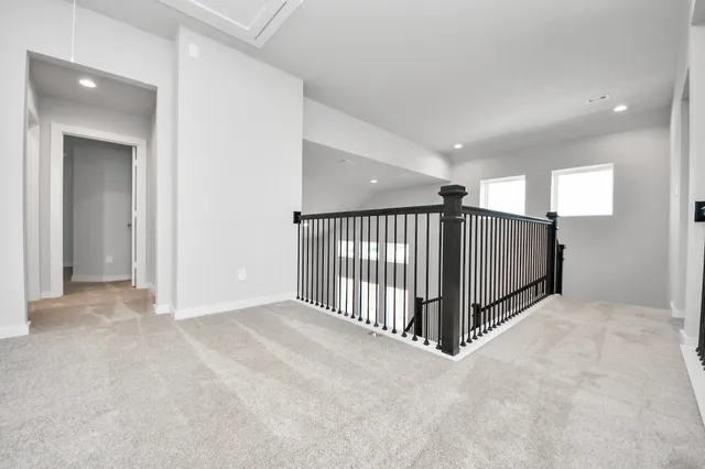 a view of an empty room with window and closet area