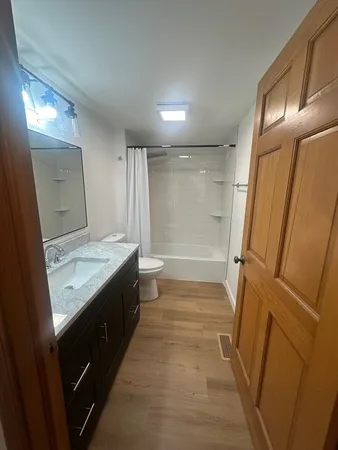 a view of a hallway and wooden floor