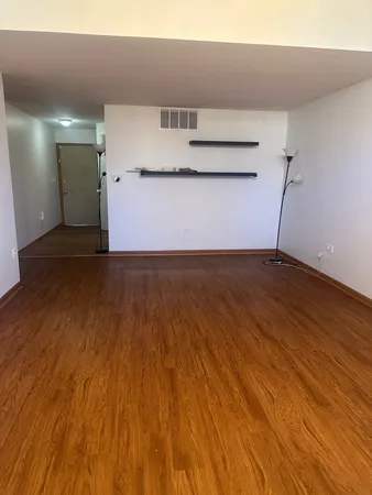 a view of kitchen with wooden floor and electronic appliances