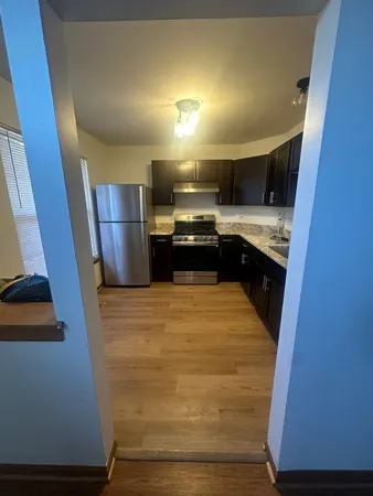 a kitchen with stainless steel appliances granite countertop a sink and a stove