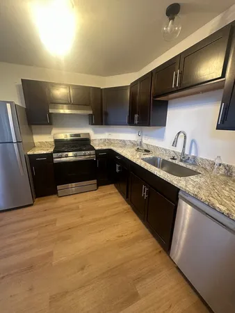 a stove top oven sitting inside of a kitchen